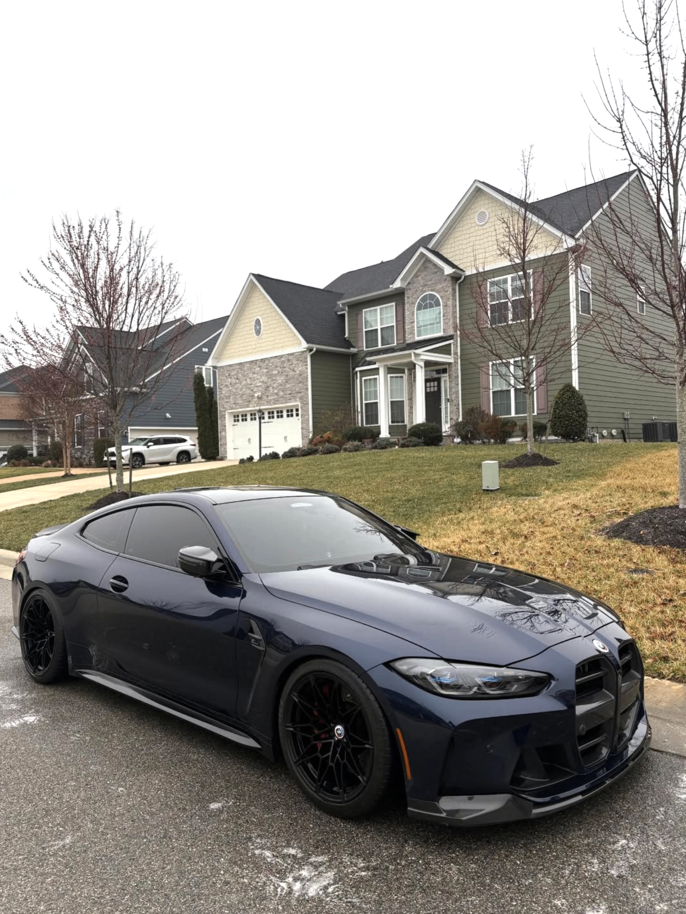 BMW M4 dark blue detailed in neighborhood
